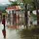 Children stand outside their flooded homes on Nov. 6, 2010, in Petite Riviere, Haiti. (Spencer Platt/Getty Images)